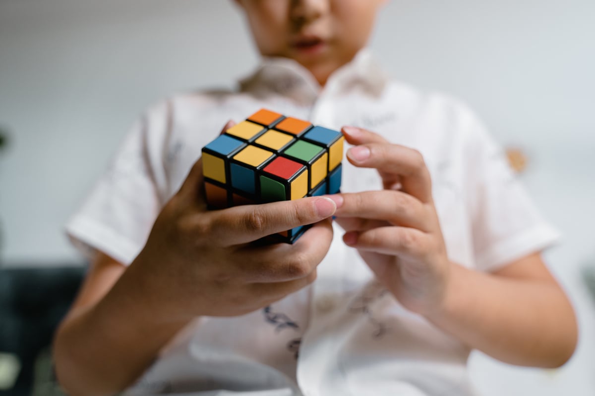 Person Holding 3 X 3 Rubiks Cube